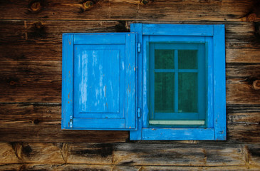Obraz na płótnie Canvas Typical serbian window with open wooden shutter in old wooden house