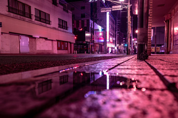 purple street light in the city at night with cyber punk color theme in Asia © PHAT