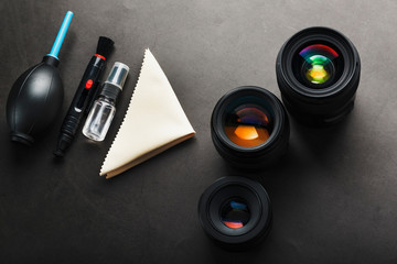 A set of tools to take care of your camera lenses on a dark background.