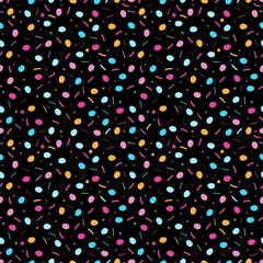 Easter dark seamless pattern with little eggs and colorful sprinkles isolated on black background.