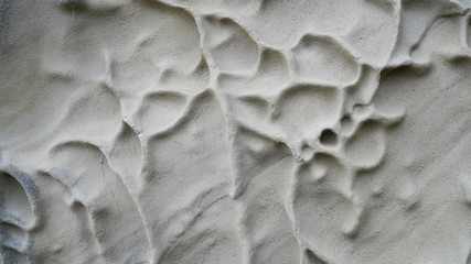 Volcanic rock cooled lava, natural pattern on stones, natural pattern on a sand wall, natural background, volcanic texture