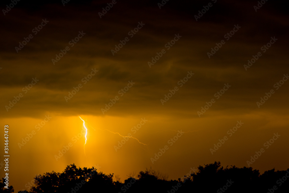 Wall mural Lightning strike on the dark cloudy sky