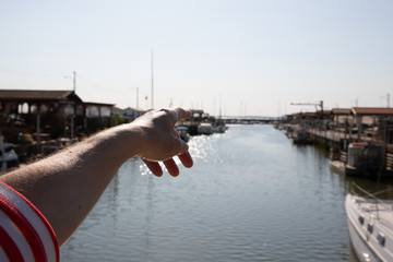 woman arm finger pointing horizon in arcachon bay in andernos harbor