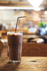Iced Mocha coffee in glass on the wooden table