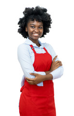 Laughing african american waitress with red apron