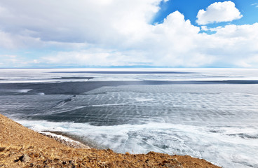 Lake Baikal on a spring sunny day. View of the ice drift and the destruction of the ice cover from Olkhon Island. Beautiful spring landscape. Natural background