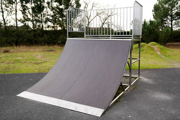 Quarter pipe ramp playground for skate practicing skateboarding adventure sport in public park