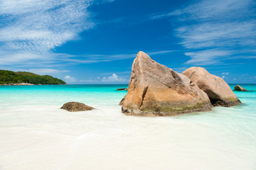 Bright scenic view of granite boulder landscape of Anse Lazio beach on Praslin Island in the Seychelles
