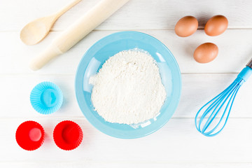 Top view photo with Kitchen Utensils on white vintage, natural, wooden background.