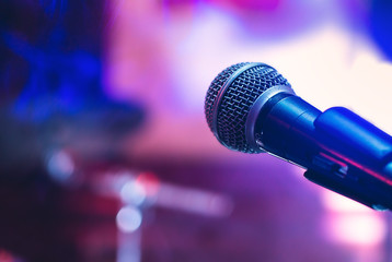 Fototapeta na wymiar Microphone at concert on violet purple background