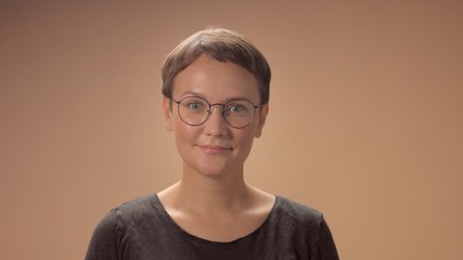 pretty caucasian woman in glasses with a short haircut portrait