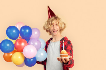 Young adult man celebrating birthday and smiling wide