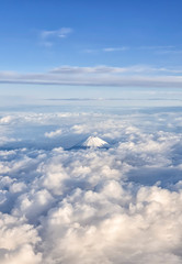 An aerial view of the Top of the Mount Fuji over the clouds, Japan