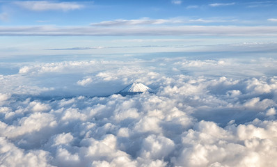 An aerial view of the Top of the Mount Fuji over the clouds, Japan
