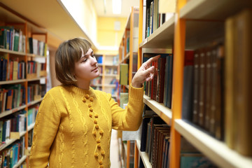 Woman chooses a book