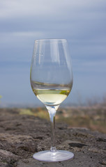 A glass of white wine on the lava stone