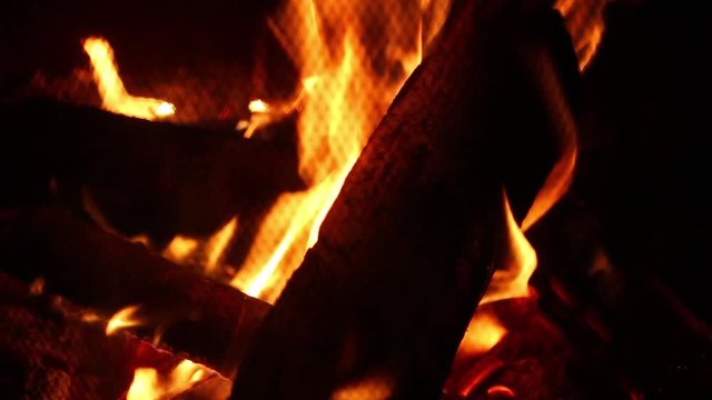 Wood fire campfire burning bright hot at night