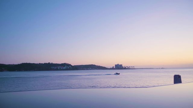 Lisbon Tagus river at sunset with sea skyline, sport boat passing and artificial lake reflection 4K