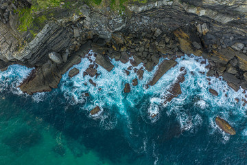 Detail of sea waves colors breaking in the coast of Lekeitio, Basque country