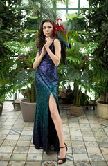 Art photo of a female homelion with a big red parrot ara in full growth