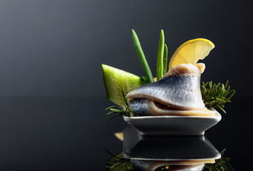 Atlantic herring with lemon, green cucumber, onion and rosemary.