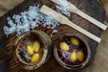 Foto op Plexiglas Sticky Rice Cooked with Coconut milk (Khao lam) or Glutinous rice roasted in bamboo joints on wooden, Thai dessert concept. © num