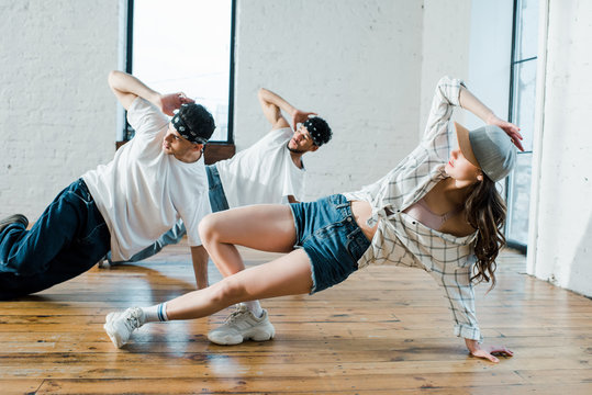 trendy multicultural dancers breakdancing in dance studio - Powered by Adobe
