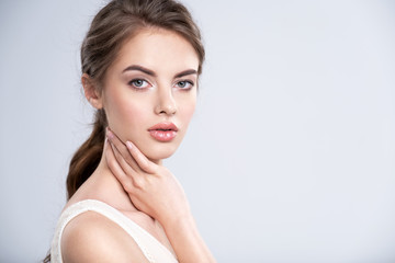 Portrait of a beautiful young woman with a brown hair.