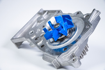 New metal automobile pump for cooling the engine of a water pump on a gray background. The concept...