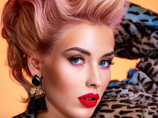 Beautiful woman with bright colored makeup. Fashionable concept. Beautiful face of young woman with...