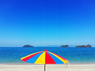 Colored umbrella and crystal clear sea