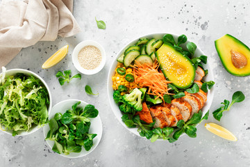 Buddha bowl with grilled chicken breast, avocado and fresh vegetable salad for lunch
