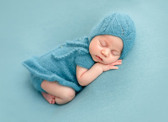 Cute newborn in knitted suit