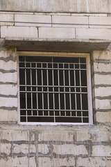 Window With Iron Metal Grills And Wooden Timber Frame Of Newly Under Construction Building Made Of Concrete Cement Blocks