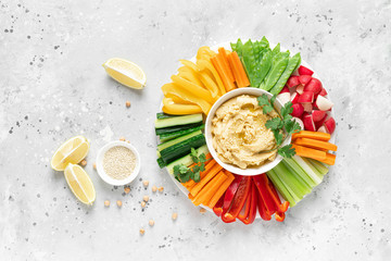 Hummus with fresh vegetables, healthy vegetarian food concept, top view