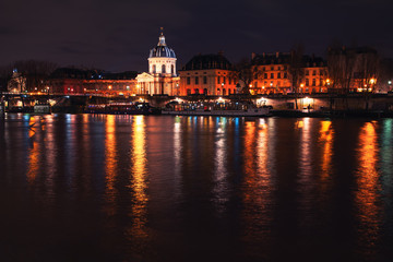 Obraz na płótnie Canvas Night view of Les Invalides and Seine River in Paris 