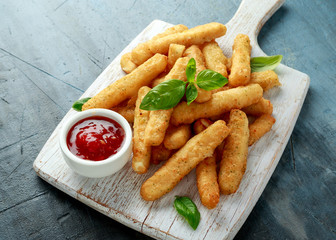 Crispy Halloumi cheese sticks Fries with sweet hot sauce on white wooden board