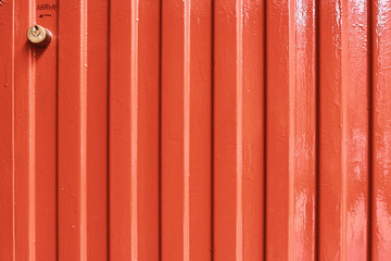 detail of orange metal garage door texture; metal background