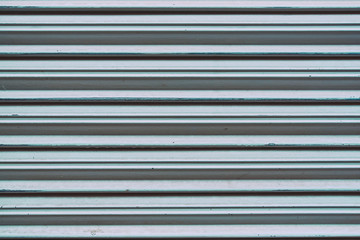 Fototapeta premium detail of metal garage or store door texture; metal background