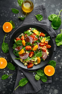 Fototapeta Vegetable Millet salad with red onion, cherry tomatoes, spinach, tangerine and clementine dressing. healthy food
