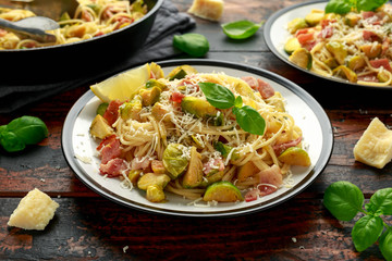 Homemade Brussels sprouts, bacon, pancetta pasta with parmesan cheese. On wooden table