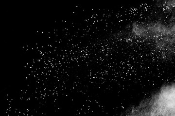 White powder explosion isolated on black background.