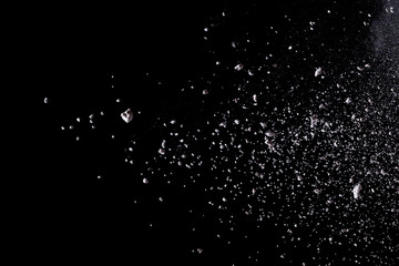 White powder explosion isolated on black background.