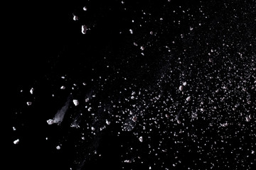 White powder explosion isolated on black background.