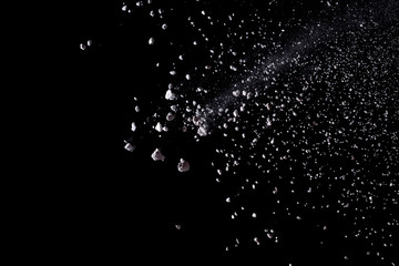 White powder explosion isolated on black background.