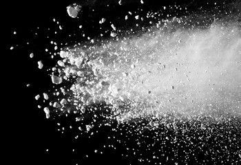 White powder explosion isolated on black background.