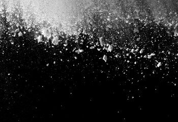 White powder explosion isolated on black background.