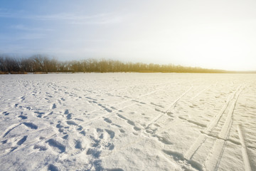Fototapeta na wymiar snowbound plain scene at the sunset