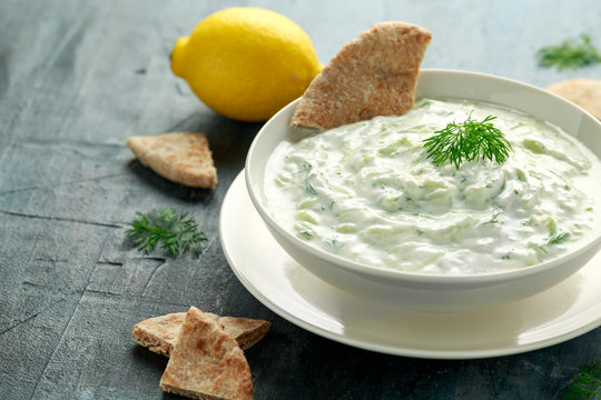 Tzatziki dip sauce with greek yogurt, garlic, dill and cucumber in white bowl