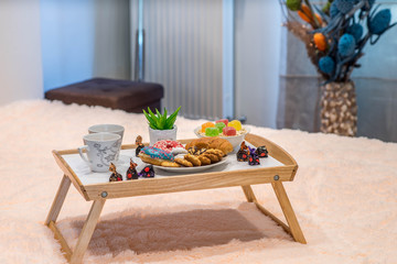 Romantic breakfast composition. Couple of cups. Cookies and sweets.